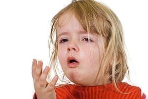 Small Child Coughing with hand up