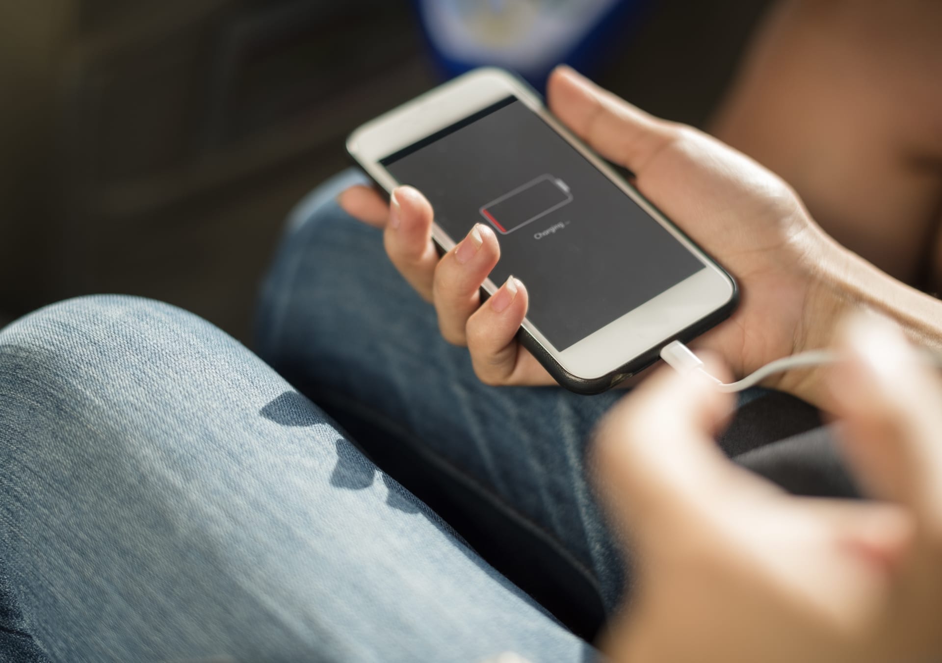 An iphone being plugged in to charge