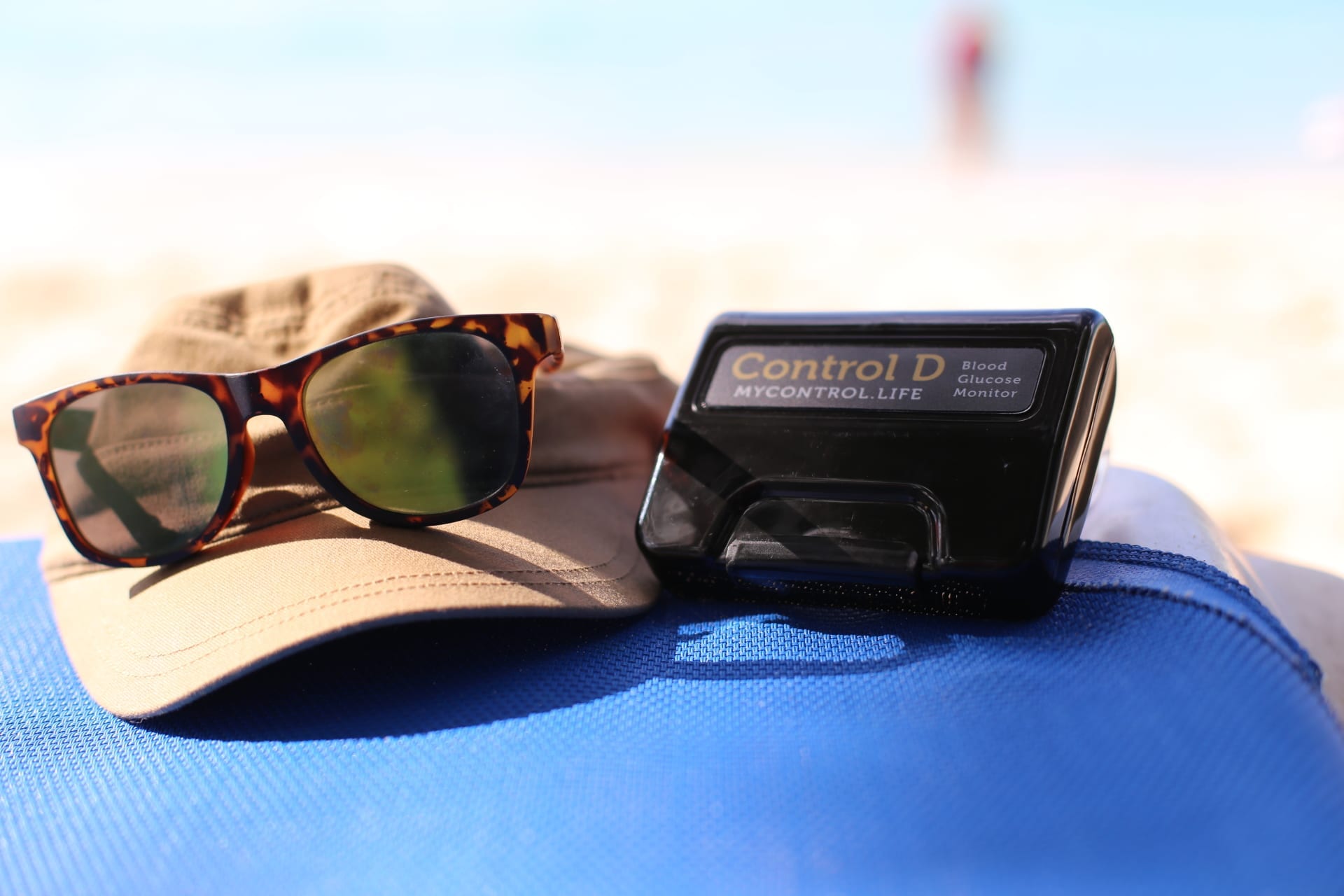 A hat, sun glasses and a diabetes blood monitor