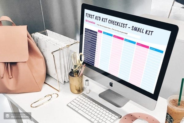 A desktop Mac on a desk with a first aid kit checklist open on the screen.