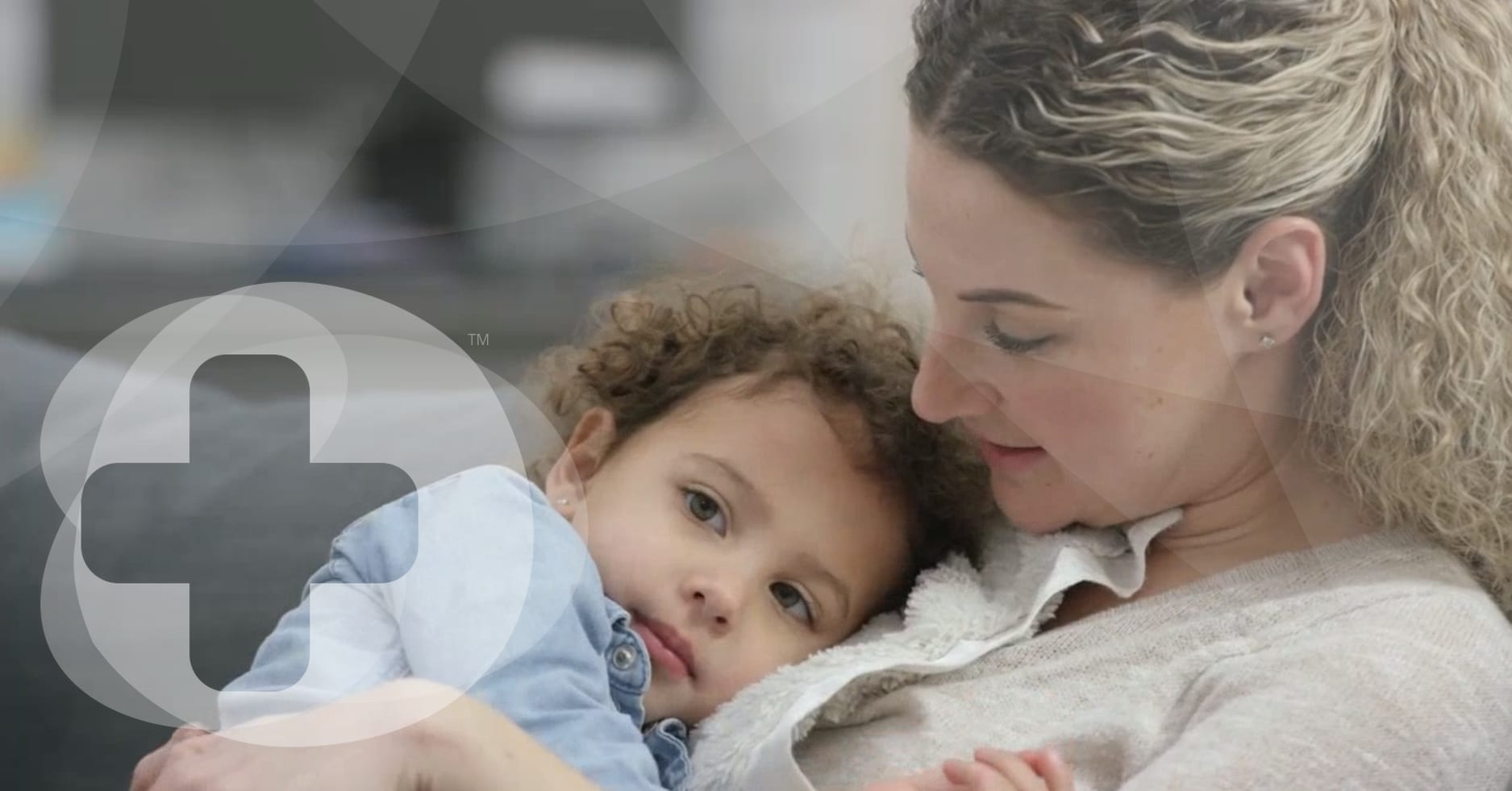a small child having a cudle with her mother. The image is overlayed with a skillbase first aid logo