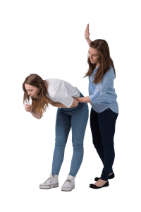 A lady bent over whilst coughing. Another woman is patting her on the back.