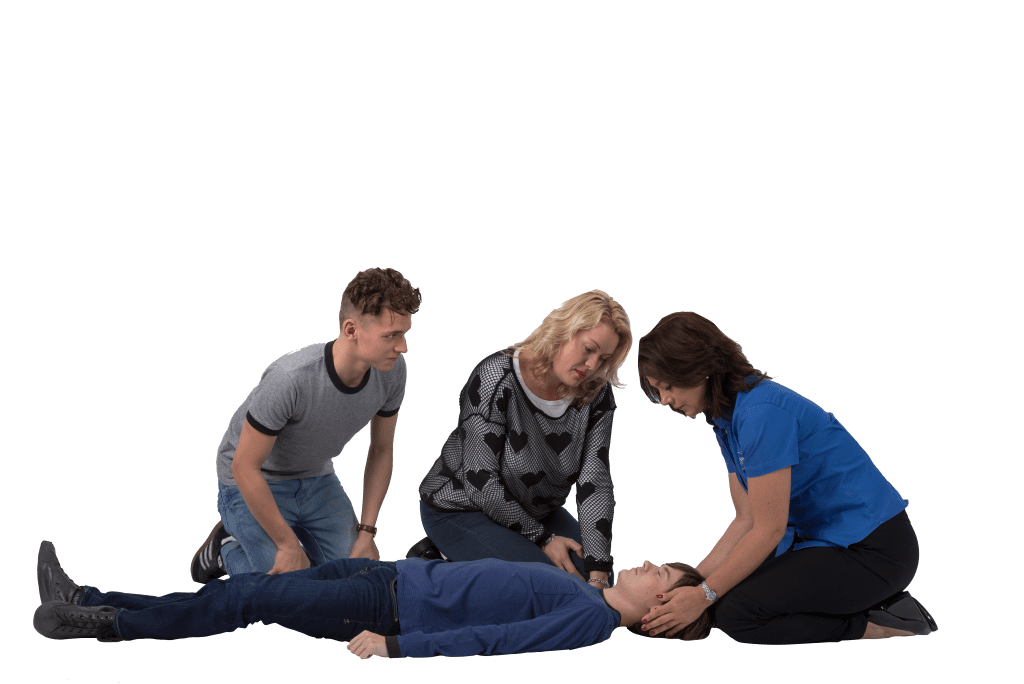 A young boy is laying on the ground unconscious whilst a lady supports the head. 2 other people are in the scene awaiting instructions.