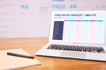 a laptop open on a table with a first aid kit checklist on the sceen.