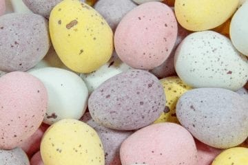A close up shot of small chocolate covered eggs.